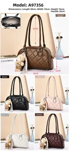 Detail of quilted shoulder bag with zipper closure and bear pendant charm accessory