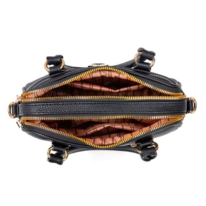 Top view of black lychee leather handbag showing triple compartments and gold zippers