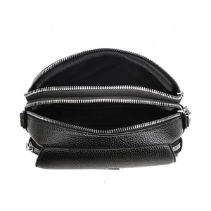 Detail view of the black lychee pattern leather bag showing three functional zip layers