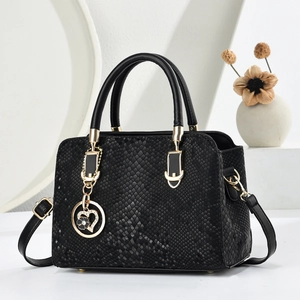 Chic black snakeskin embossed handbag for women with gold hardware and heart charm