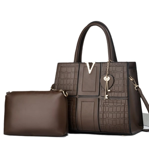 Deep brown tote bag with V-shaped metal hardware and crocodile texture patchwork
