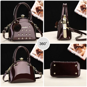 Multi-angle view of wine red patent leather handbag with floral charm and gold hardware