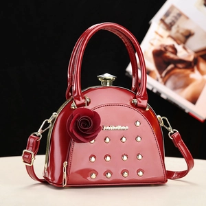 Red patent leather handbag with gold rivets and rose pendant in trendy Korean style