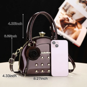 Detail of burgundy patent leather handbag with gold studs and size dimensions displayed