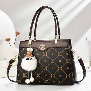Macro detail of the classic monogram texture on this dark brown and black leather tote bag