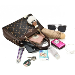 Brown monogram handbag showing large capacity with daily essentials spilling out
