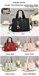 Quilted crossbody bag with stud details and cherry charm showing size 25x11x17cm