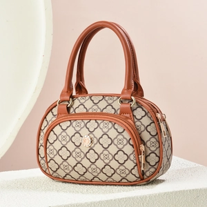 Mini tote bag with beige clover pattern, brown leather trim, and gold logo detail