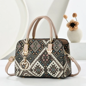 Elegant woven geometric handbag with leather handles and a heart flower charm accessory
