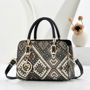 Elegant vintage geometric floral tapestry handbag with black handles and metal charm
