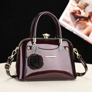 Elegant deep wine red patent leather handbag with gold hardware and crystal clasp