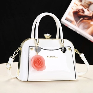 Elegant white patent leather shell bag with rose charm and metallic top handle design