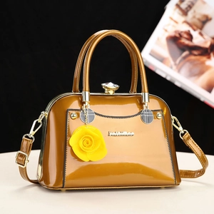 Elegant vintage brown lacquer leather handbag with metal handle and yellow rose charm