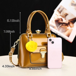 Detail of glossy brown handbag showing dimensions 8.66x7.09x4.33 inches with rose charm