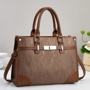 Retro contrast-color tote bag with brown leather handles and silver metal clasp detail