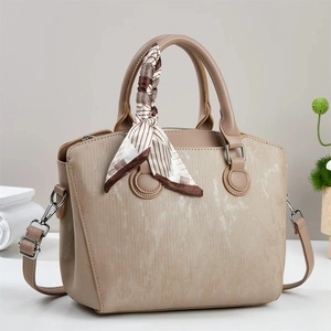 Beige tote bag with wood-grain texture and decorative silk scarf on handle