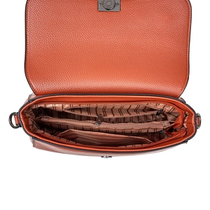 Detail view of brown pebbled leather handbag featuring multi-compartment interior and lining