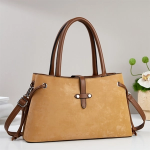 Ginger yellow matte leather crossbody handbag with brown straps shown on a clean white surface