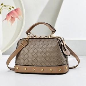Sac à main chic en cuir tressé marron avec clous dorés et bandoulière amovible sur fond blanc