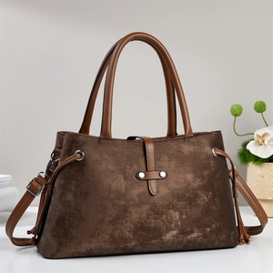 Vintage dark brown trapezoid handbag with adjustable strap and rivet buckle details