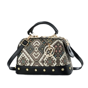 Chic bohemian patterned tote bag with black leather accents and golden rivet detailing