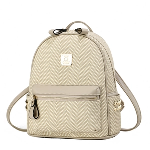 Detail of herringbone woven texture and faux leather trim on a stylish women's backpack
