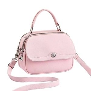 Pink pebbled leather handbag with double zippers and lucky clover charm in 45-degree view