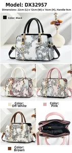 Detail view of paisley crossbody bag showing internal zipper pockets and dimensions