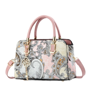 Elegant paisley print handbag for women with golden floral pendant and top handle