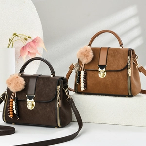 Detail of vintage tote bags in dark brown and khaki with suede texture and tassels