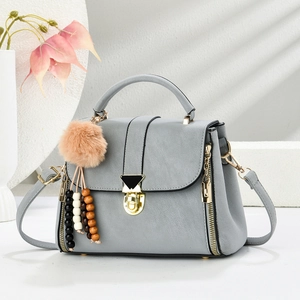 Gray textured PU leather crossbody bag with golden hardware and plush bead charm