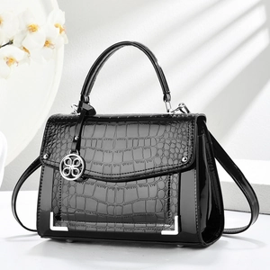 Elegant black faux crocodile leather handbag with silver flower pendant and metal corners