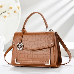 Glossy brown crocodile pattern crossbody bag with round silver pendant and top handle