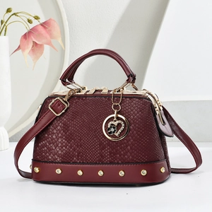 Elegant wine red snakeskin texture handbag with gold rivets and heart pendant