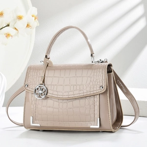 Chic beige crocodile embossed handbag with glossy finish and silver metal hardware details