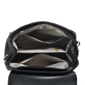 Interior view of black pebbled leather bag with three compartments and gold zipper