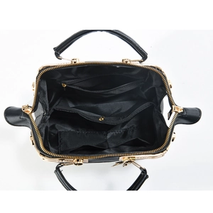 Top view of the black tote bag interior showing multiple functional compartments and gold zipper