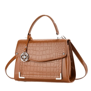 Caramel brown crocodile embossed leather handbag with silver hardware and shoulder strap