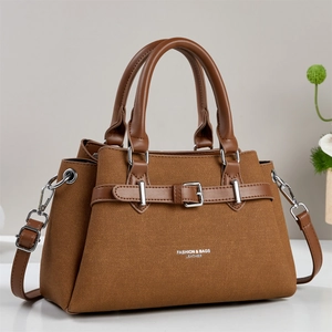 Brown fabric handbag with leather handles and adjustable crossbody shoulder strap