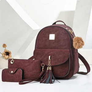 Three-piece burgundy suede backpack set with golden hardware and tassel charms