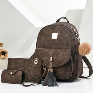 Three-piece set of brown vintage faux leather backpack with stylish tassel and pompom charms