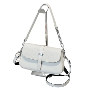 White square shoulder bag with woven texture flap and silver chain on metal stand