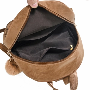 Internal view of the brown suede backpack featuring a black lining and a zippered pocket