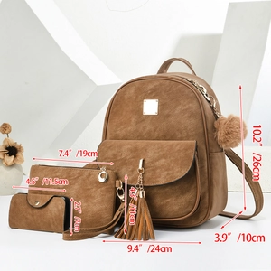 Brown suede 3-piece set with backpack, clutch, and wallet featuring tassel and fur ball