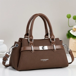 Brown leather and canvas crossbody bag with silver twist lock and adjustable shoulder strap