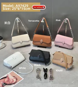 Detail view of leather shoulder bag in six colors with metal lock and chain strap