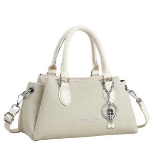 Chic cream leather tote bag for women featuring silver hardware and a clover charm