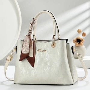Elegant beige pearl stripe handbag with decorative silk scarf and gold metallic hardware