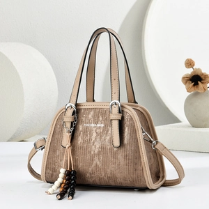 2025 minimalist structured handbag in tan with brushed texture and beaded tassel charm