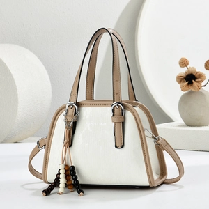 Minimalist beige and brown color-block handbag with beaded tassel on a geometric background